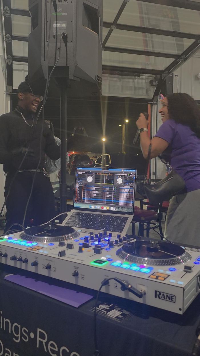 Guest singing karaoke with DJ Sir Uso on a mobile DJ controller