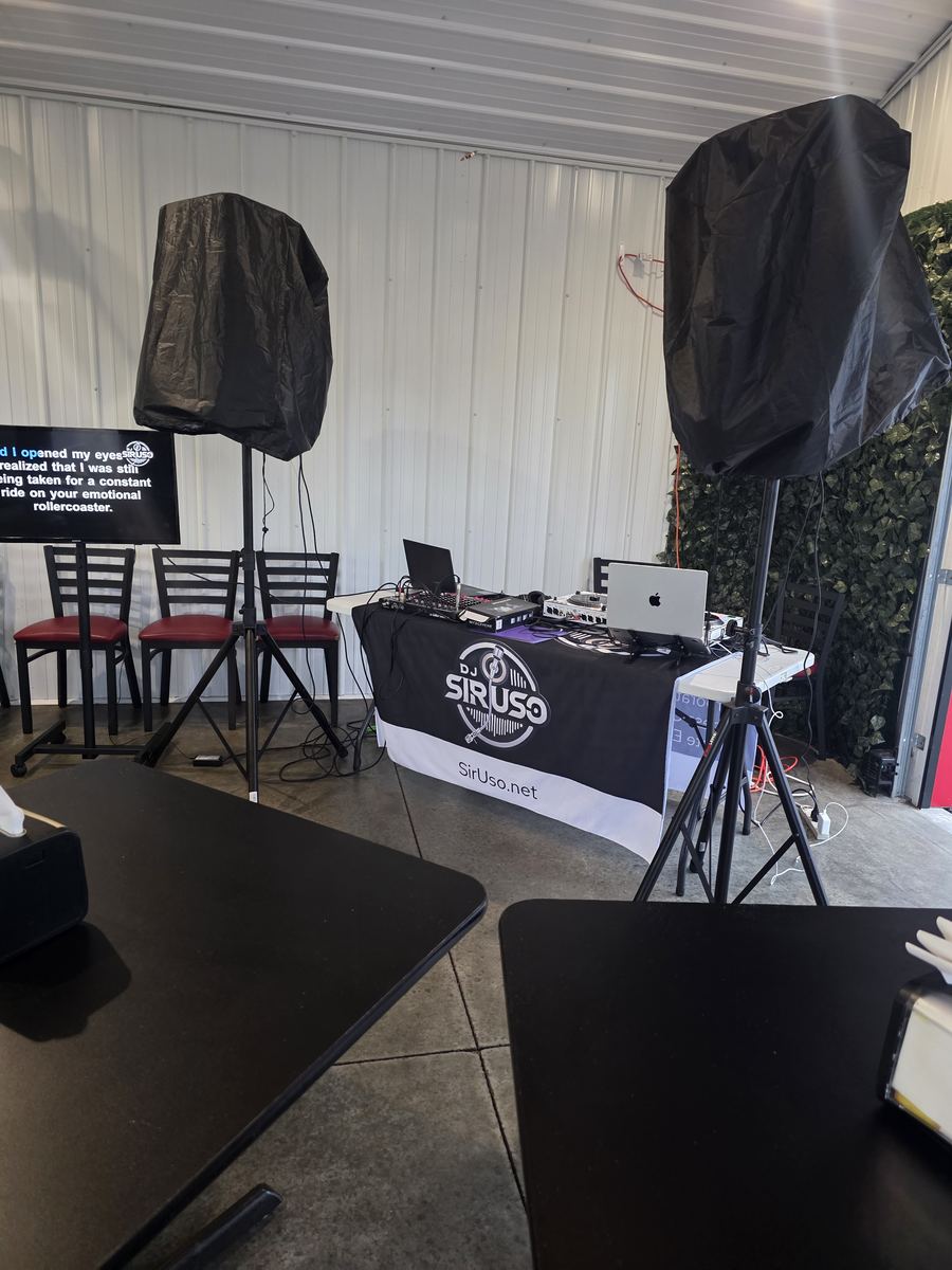 DJ Sir Uso karaoke and DJ setup with sound system and lyrics display at a community event