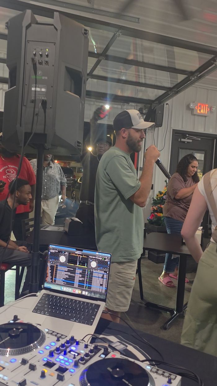 DJ Sir Uso emceeing and hosting karaoke on the microphone at a community event